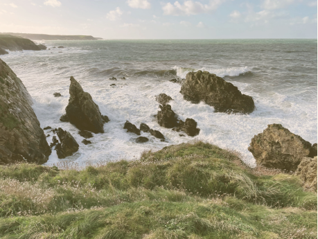 waves crashing into coastline nefyn golf club